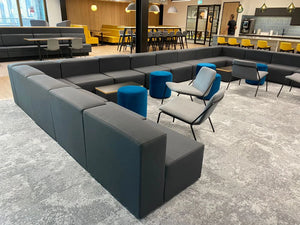 Frank Modular Upholstered Seating with Table and Blue Round Pouffe Stool in Office Collaborative Area