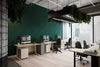Acoustic Wall Panel in Dark Green with Sit Stand Desk and Black Armchairs in Office Setting 2
