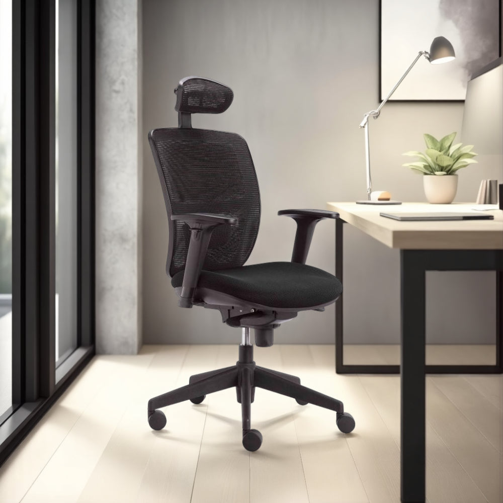 Action Ergonomic Mesh Chair in Black Finish with Wooden Table and Indoor Plant in Modern Office Setting