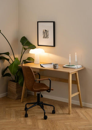 Brycen Home Office Desk with Mobile Chair and Indoor Plant in Home Office Setting