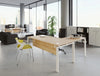 Buronomic Astro Desk for Open Space 2 in wood finish top with white legs in office with books on top