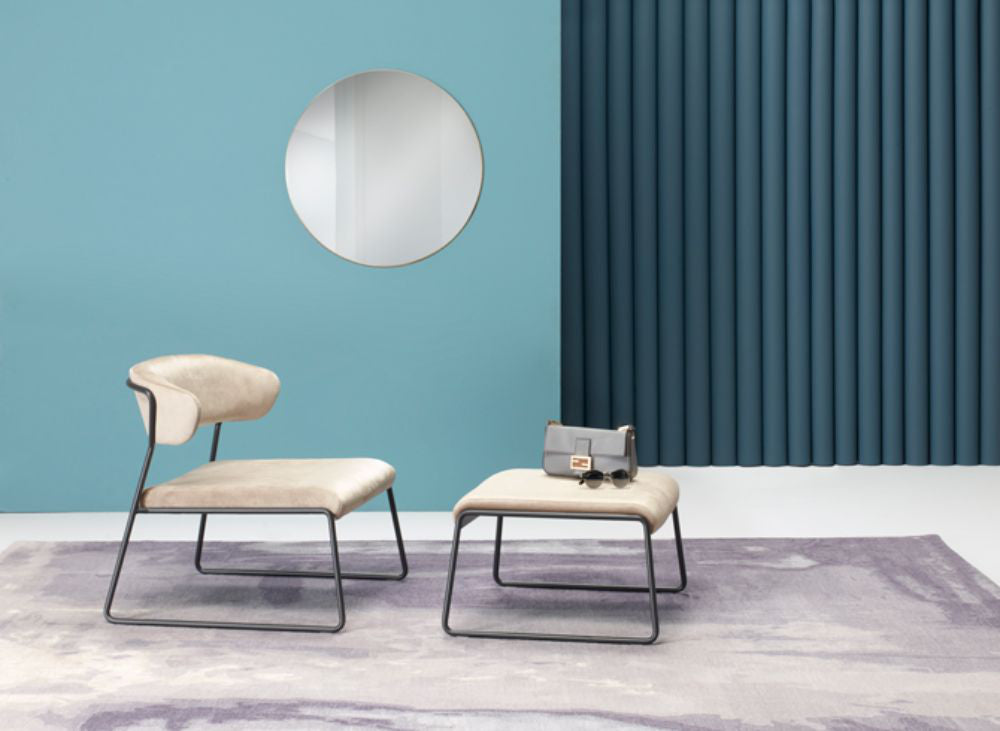 Lisa Lounge Armchair With Pouffe And Wall Mirror In Studio Setting