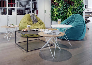 Loft Round Coffee Table In Wooden Top Finish With Upholstered Blue Bean Bag And White Bookshelves In Breakout Setting