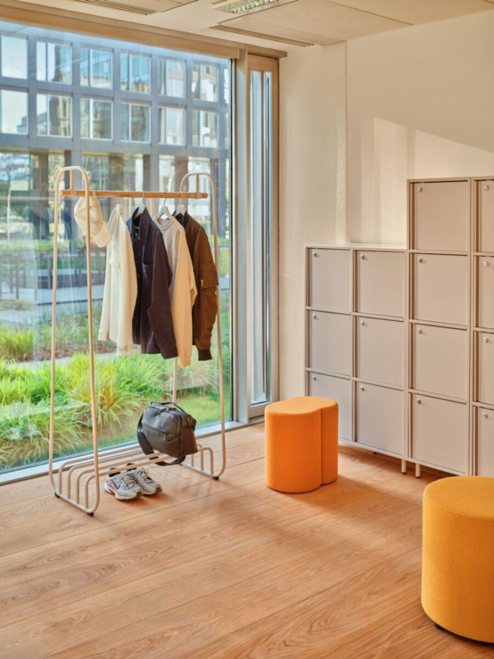 Mix Cube Soft Seating Geometric Pouffe with Coat Rack and Lockers in Modern Office Setting