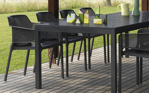 Nardi Net Stackable Monobloc Armchair in Anthracite with Black Table and Playing Blocks in Outdoor Settings