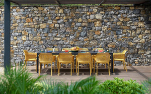 Nardi Net Stackable Monobloc Armchair in Mustard with Black Rectangular Table in Outdoor Settings