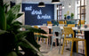 Nardi Thrill Stackable Monobloc Chair with Armrest in Different Finishes with Long Table in Cafeteria