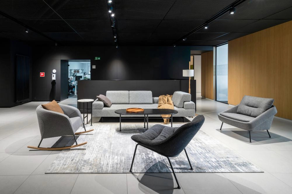 Nome Loose Backrest Lounge Chair in Grey with Grey Rocking Chair and Oval Shaped Low Table in Living Room Setting