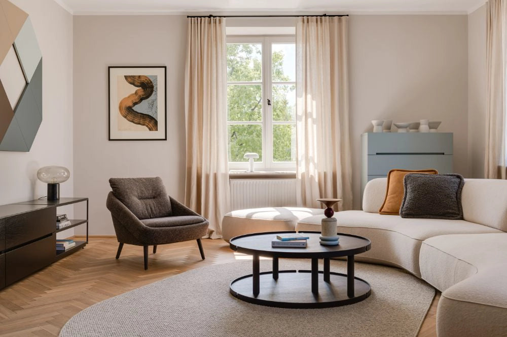 Nome Loose Backrest Lounge Chair in Taupe with Round Centre Table and Off White Modular Sofa in Living Room Settings