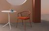 Panarea Dining Chair with Armrests in Brown Finish with Round Table in Studio Setting 2