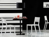 Pedrali Feel Sled Base Solid Wood Chair 11 In White Finish With Black Table In Cafeteria Setting