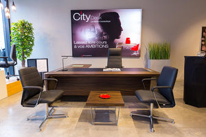 Quadrifoglio X10 Executive Desk In Ebony Finish With Wooden Top Coffee Table And Black Armchair In Office Setting