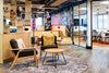 Scandi Upholstered Lounge Armchair With Coffee Table And Shelves In Breakout Setting