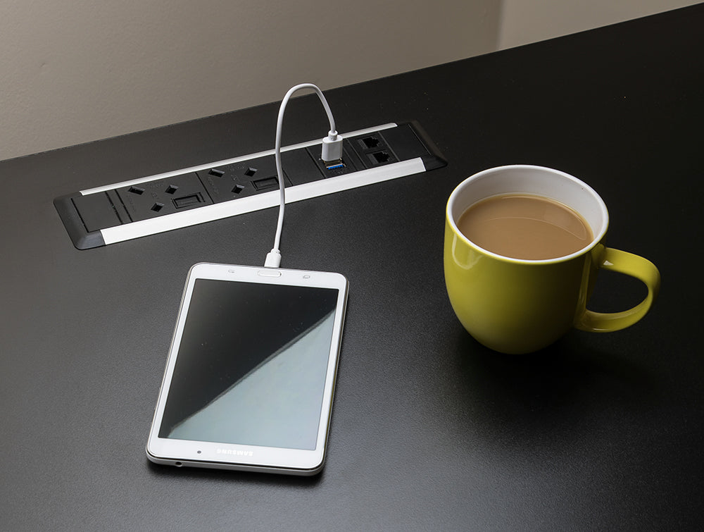 Slimline Omega 2 UK Sockets In Desk Power Module Black Attached in the Table