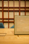 Solo T Rattan Desk Screen with Meeting Table in Modern Office Setting
