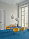 Ultra Office Chair on 4 Legged Metal Legs with Table and Bookshelf in Modern Office Setting