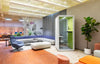 Zum Phonebooth in White Finish with Lounge Chairs and Indoor Plant in Reception Setting